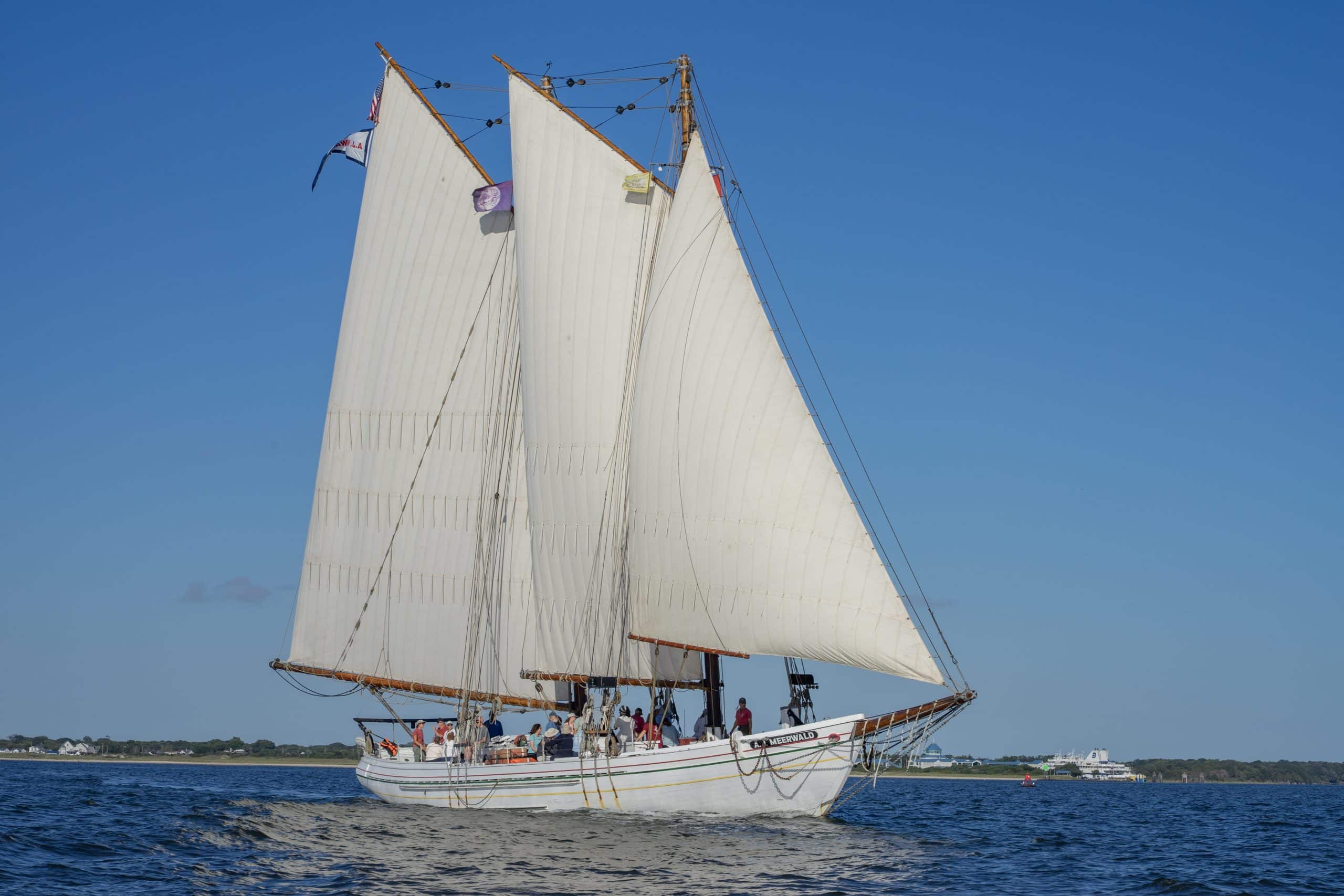 A.J. Meerwald Sailing on the Delaware Bay The historic oyster schooner A.J. Meerwald sailing with full white sails raised on the Delaware Bay near Cape May, New Jersey.
